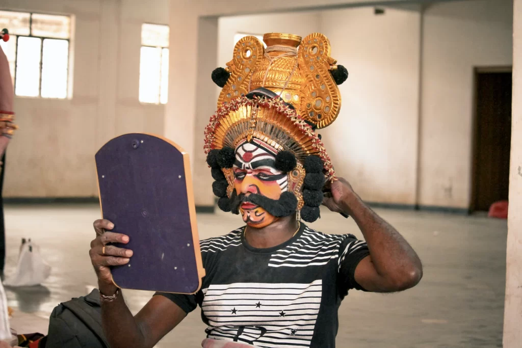 A male actor in culturally appropriate headdress and makeup.
